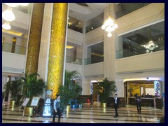 The lobby of Panglin Hotel has sculptures, fountains, marble floors and panels and glass enclosed elevators.